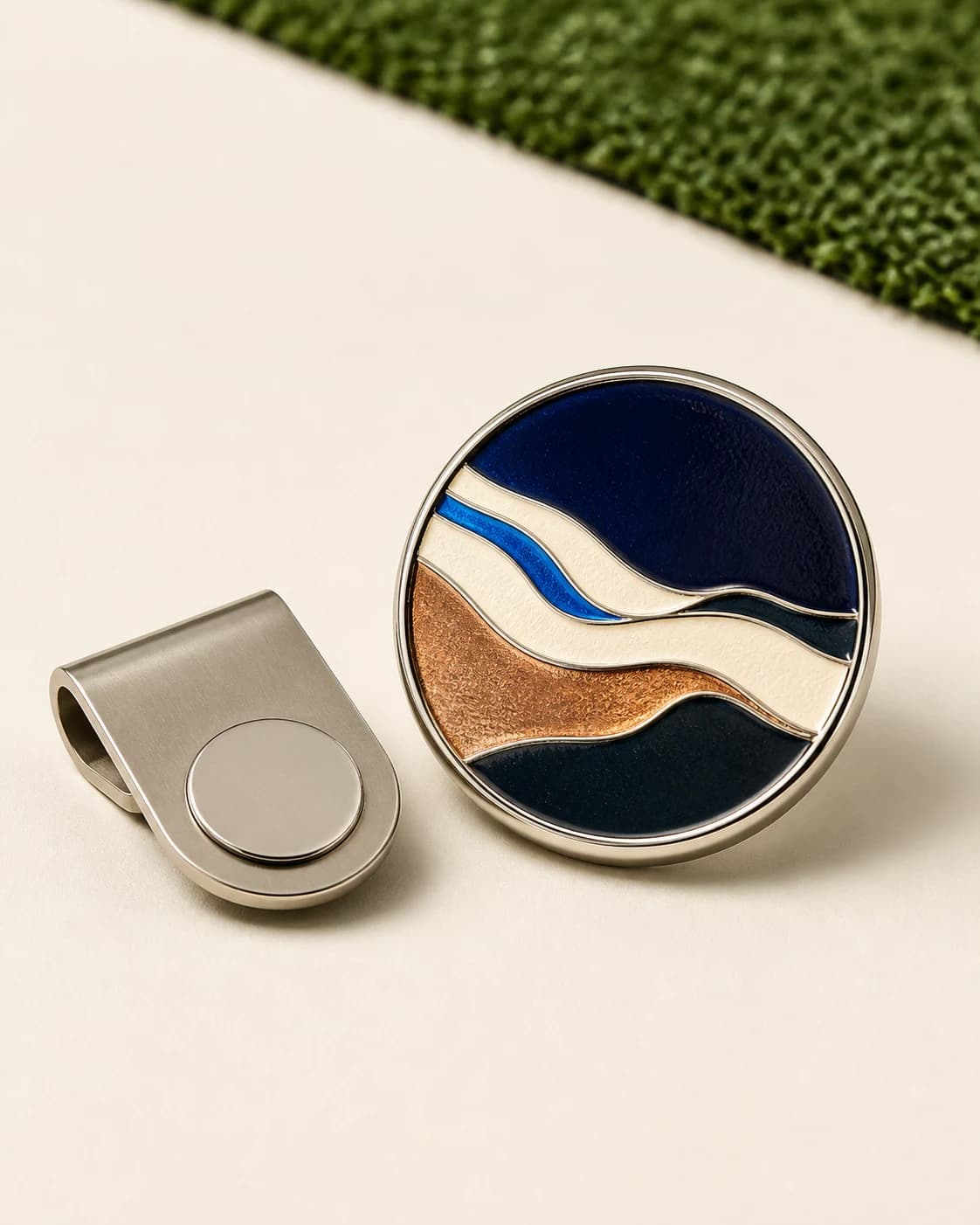 Personalized stainless-steel golf ball marker beside a premium golf ball