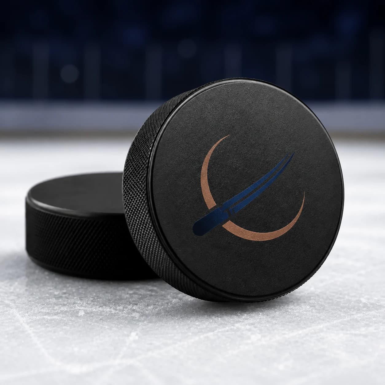 Custom hockey puck with a navy and copper printed mark on an ice surface